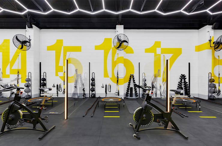 sectioned gym areas filled with exercise equipment