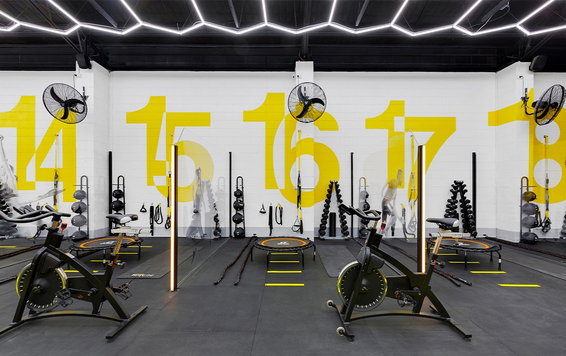 sectioned gym areas filled with exercise equipment