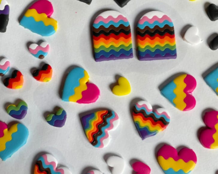 Colourful polymer clay pieces on a white table.