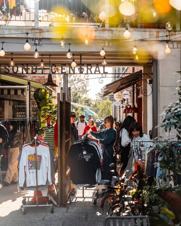 People peruse Ponsonby Central's laneway set-up for market day.