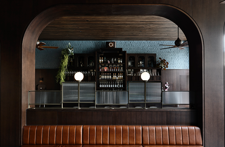 An art-deco style bar with dim lights and a full bar.