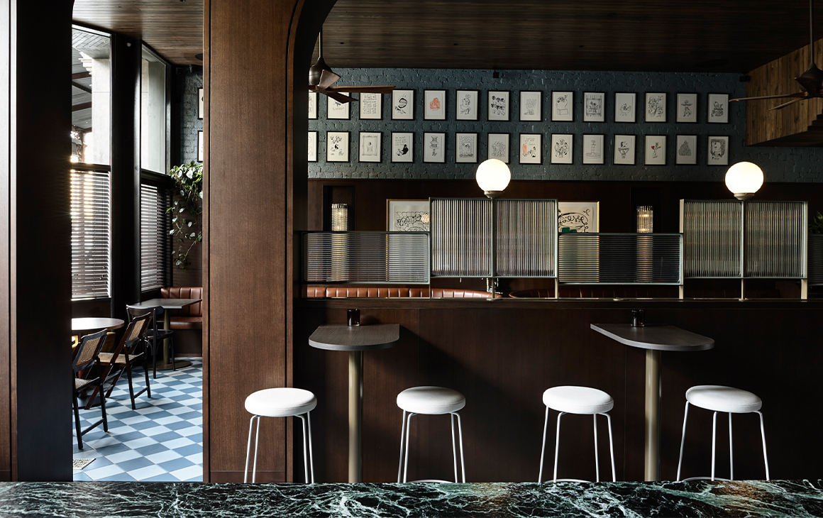 A marble bench and white stools inside in one of the best bars of Melbourne. 