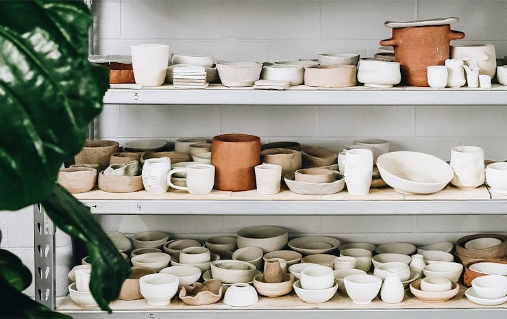 shelves full of drying pottery