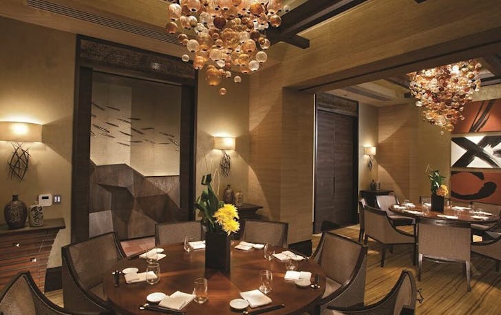 two round dining tables in a private room at Nobu