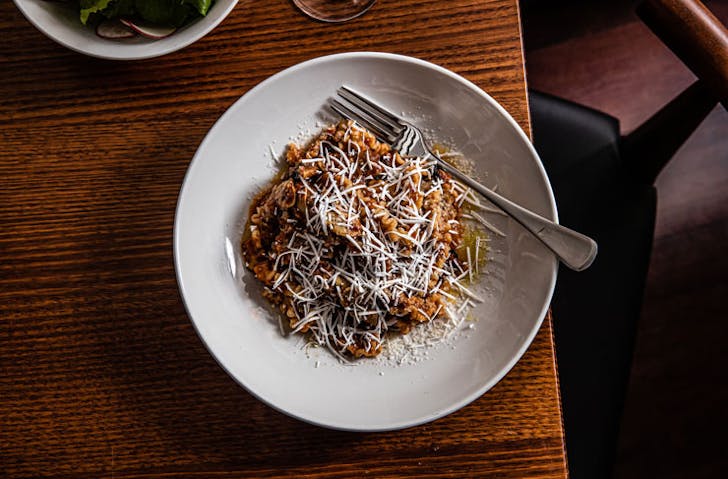 A bowl of pasta with grated cheese