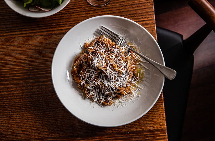 A bowl of pasta with grated cheese