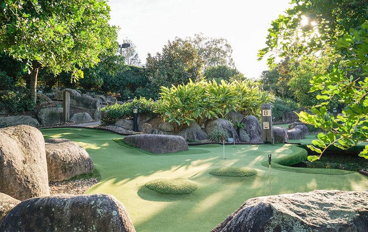 A putt putt course surrounded by trees
