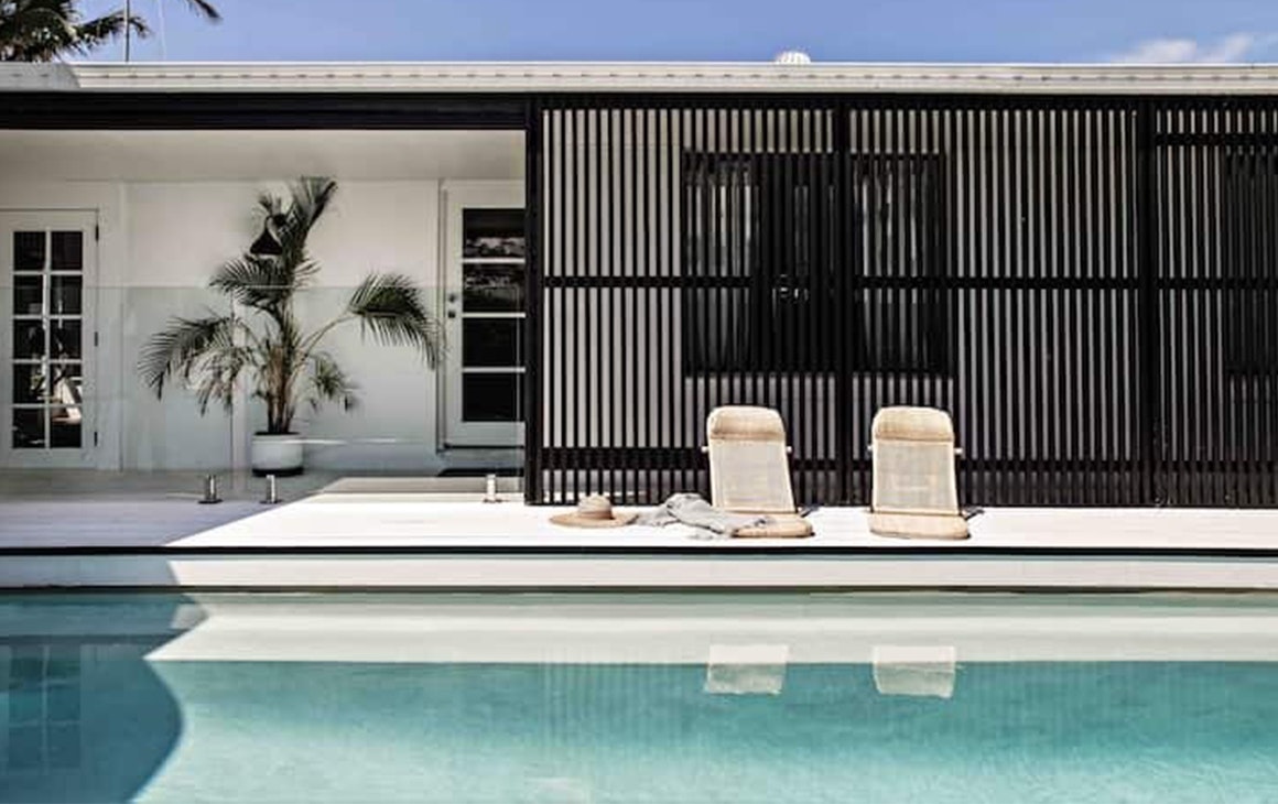 A coastal style cottage, with a pool.
