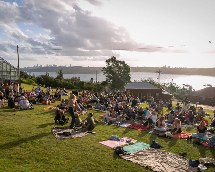 q station manly sunset sessions people picnicing on the hill with a view of manly