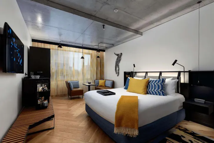 A bedroom at QT Melbourne one of the best luxury Melbourne hotels