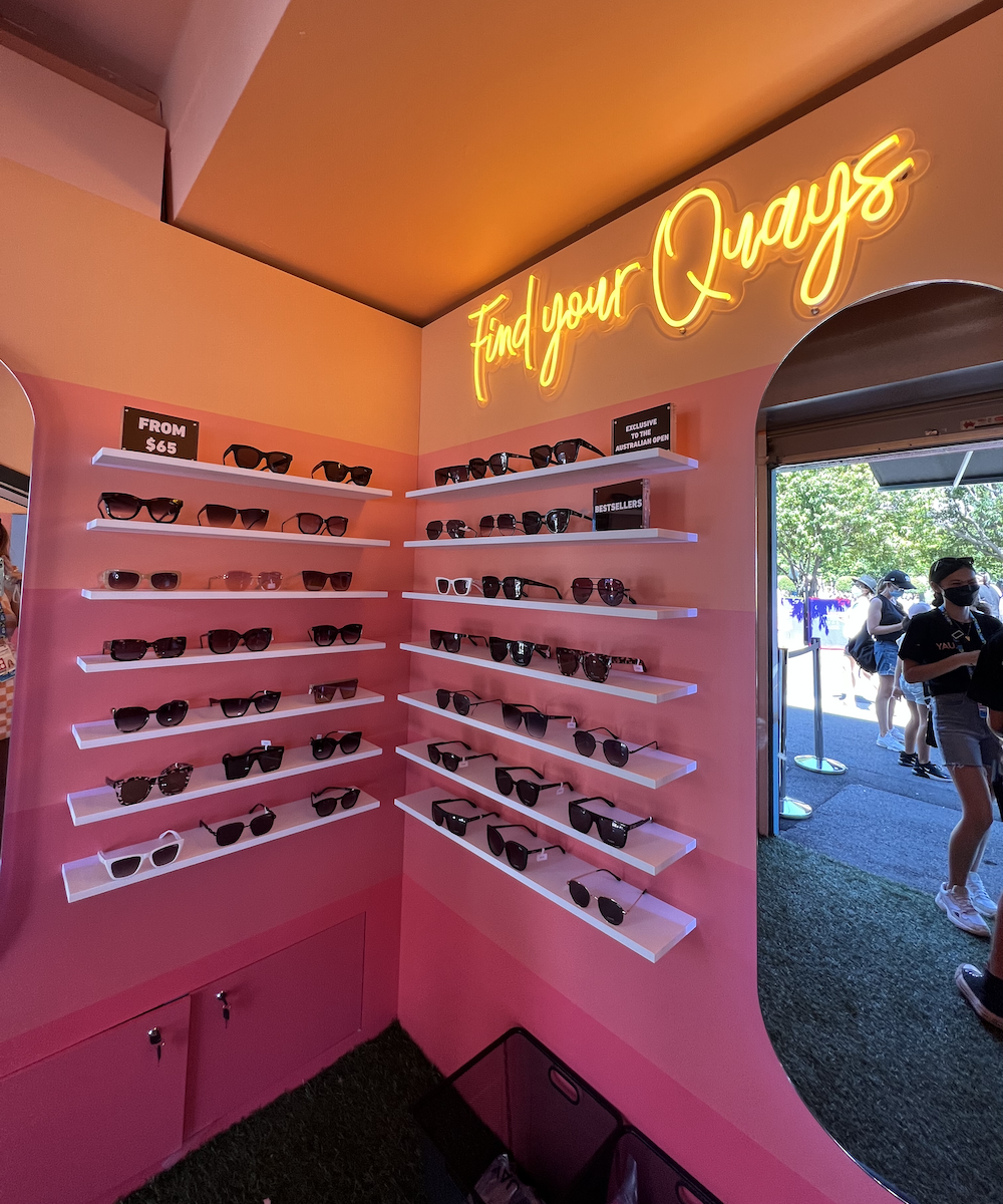 a pink pop-up store with Quay sunglasses