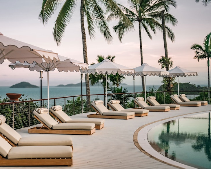 Sunloungers around the pool at The Elandra one of the best romantic getaways Queensland