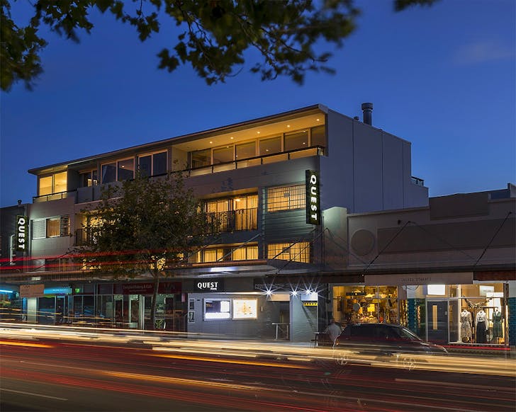 The outside of the Quest Ponsonby on Ponsonby Road is shown at dusk.
