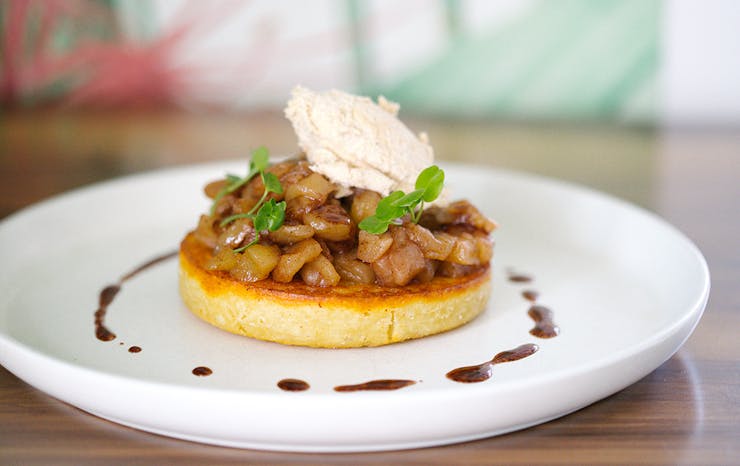 a crumpet topped with cooked apple and cream