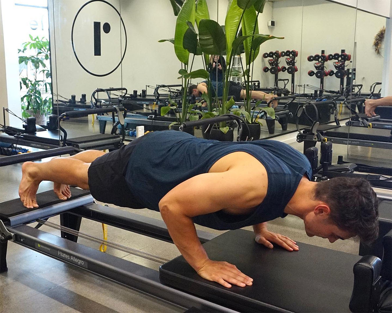 A man works out at Reform Pilates, one of the best pilates studios in Auckland.