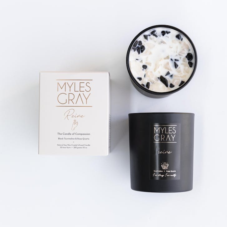 a black candle with black and white crystals