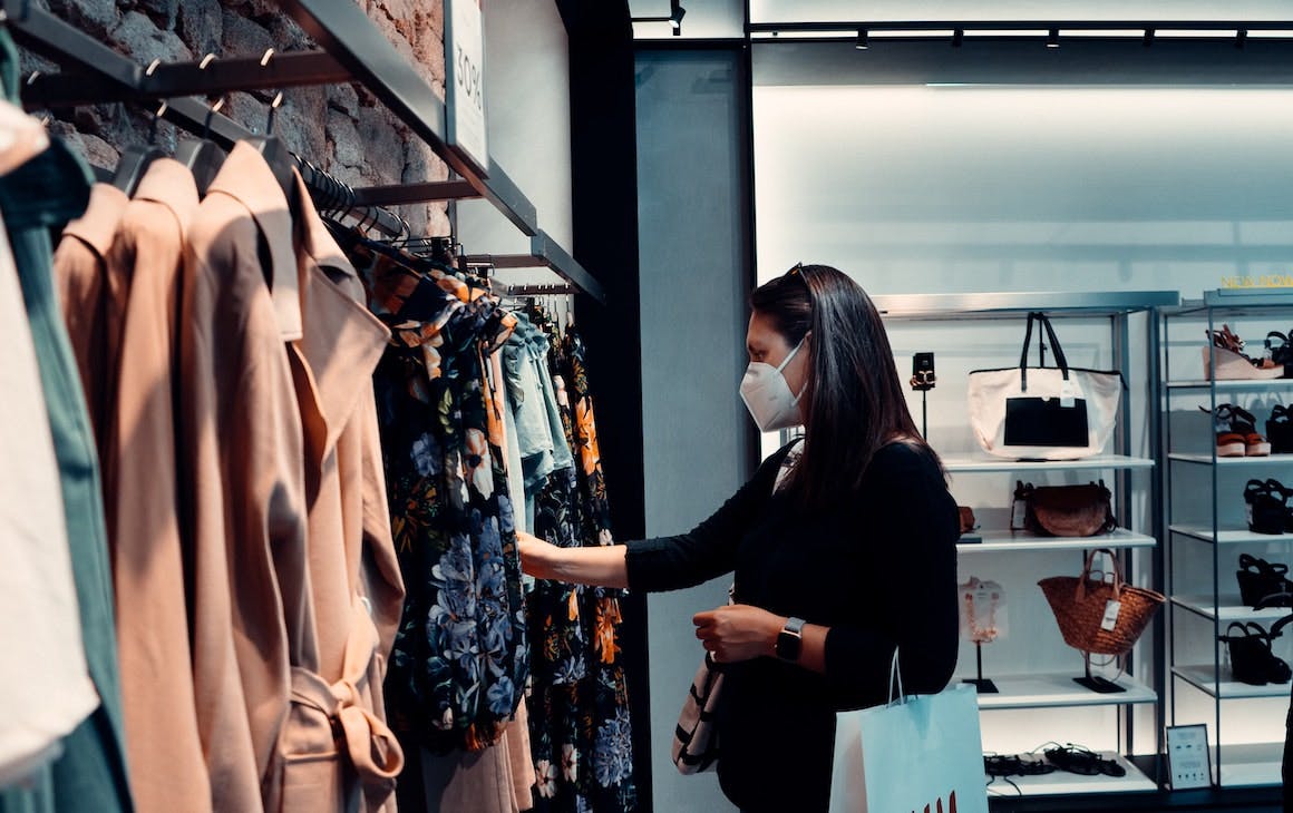 a woman shopping in a respirator mask