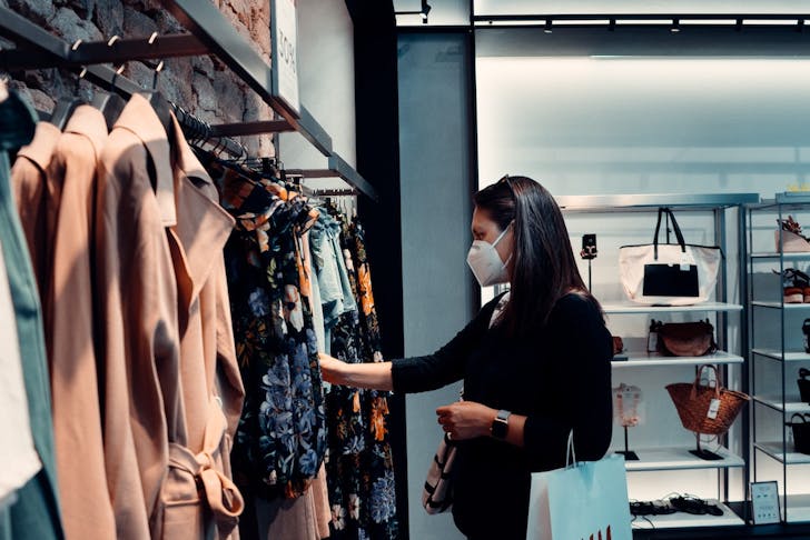 a woman shopping in a respirator mask