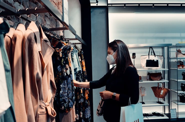 a woman shopping in a respirator mask