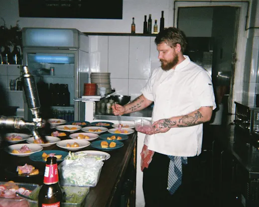 Chef-owner Robin Butler plates dishes during dinner service at Nest, the Newtown cafe and restaurant he reopened in the former Rolling Penny space.