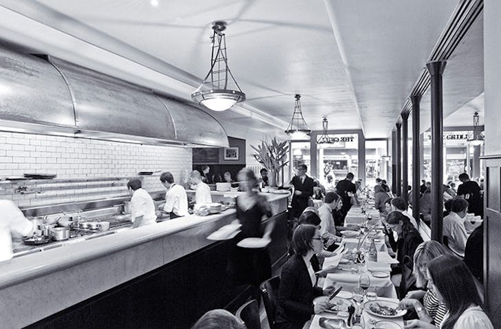 A black and white photo of a dining room at a christmas party Melbourne venue.