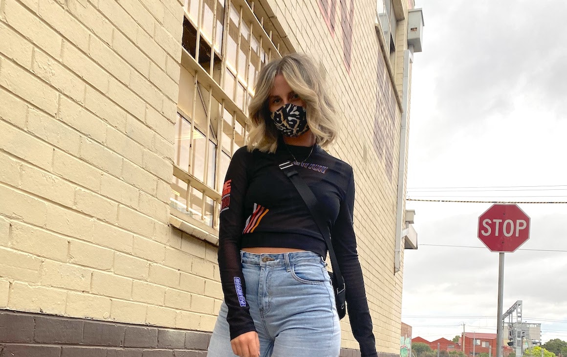 a woman wearing a face mask on the street