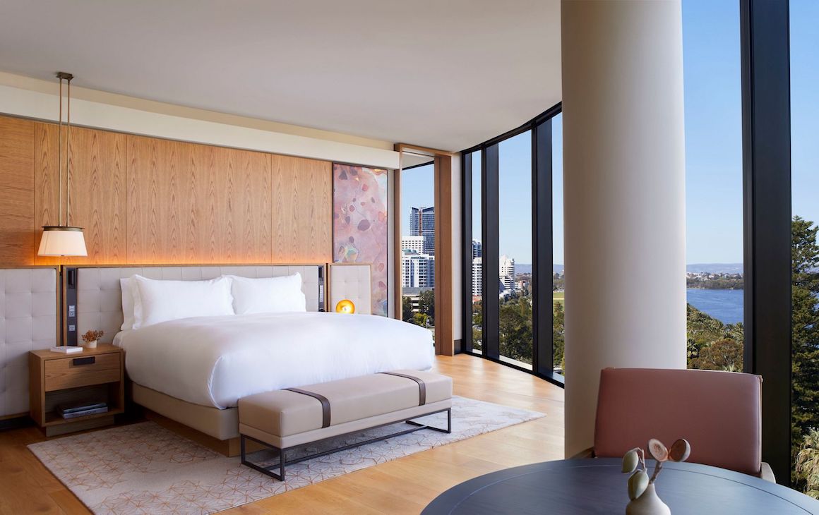 bright and airy hotel room with floor to ceiling windows