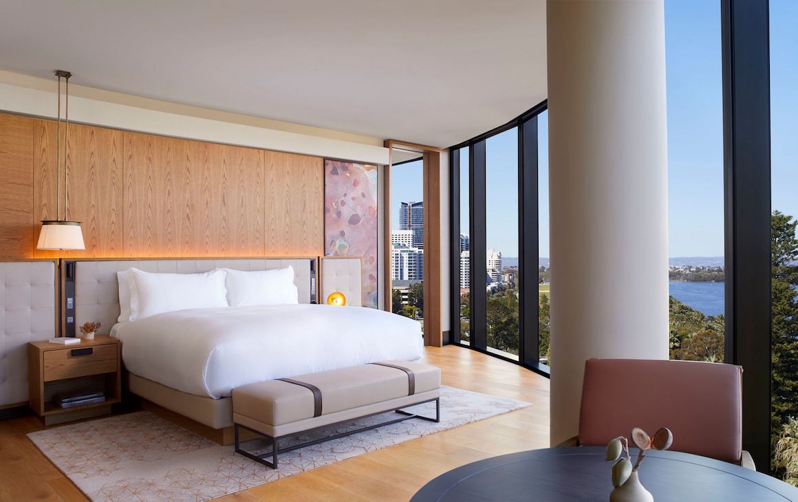 a light and bright hotel room with floor-to-ceiling windows