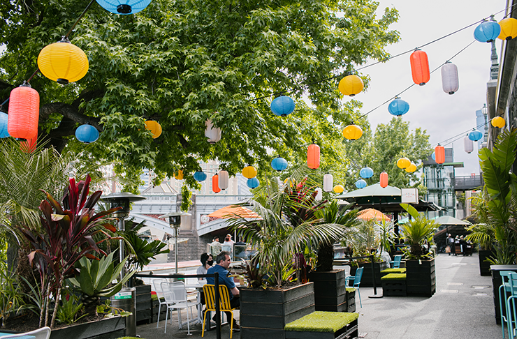 A bar by the Yarra River filled with plants.