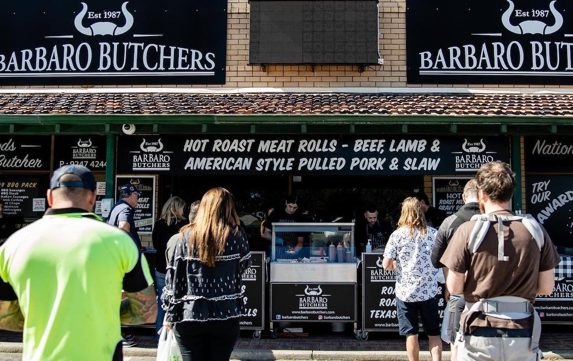a butcher serving roast meat rolls in Perth