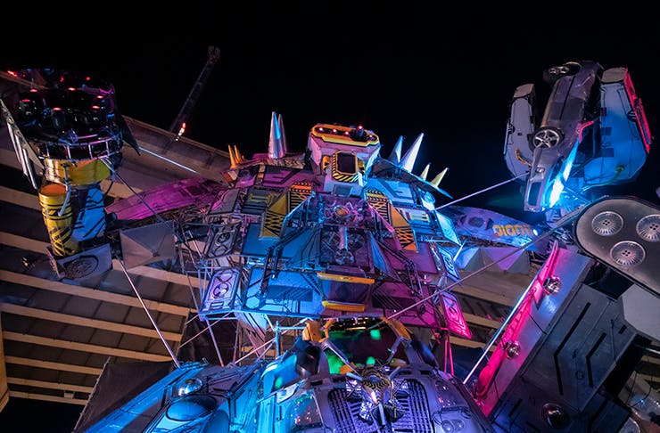 A large robot installation towering up into the night sky.