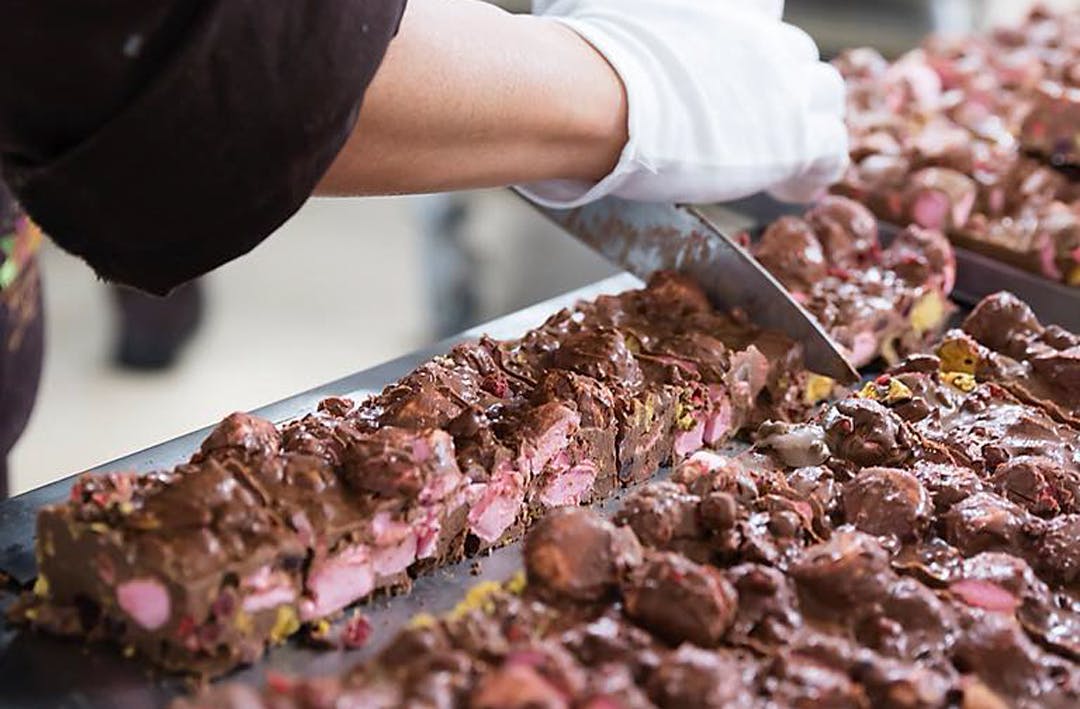 rocky road chocolate being cut up into squares.