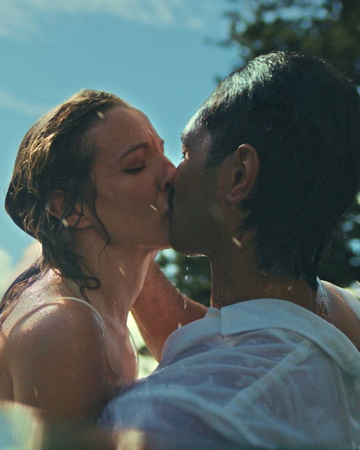 Soaked in water, the two stars of Romeo & Juliet kiss.