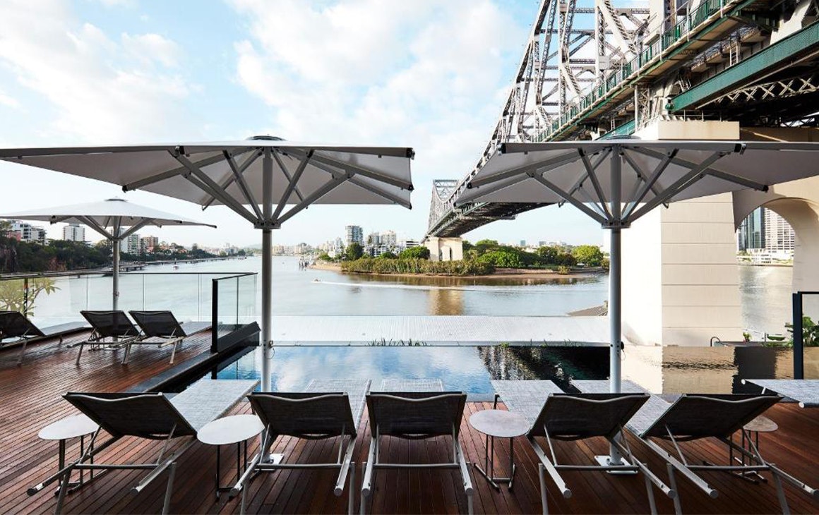 rooftop pool overlooking the story bridge and river