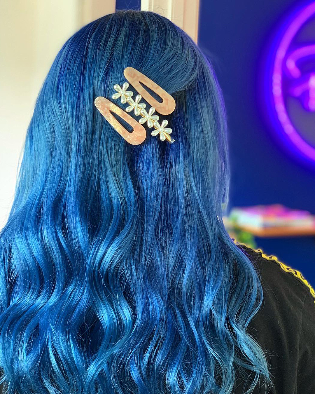 Someone shows off their blue hair at Rose Quartz Hair Studio.