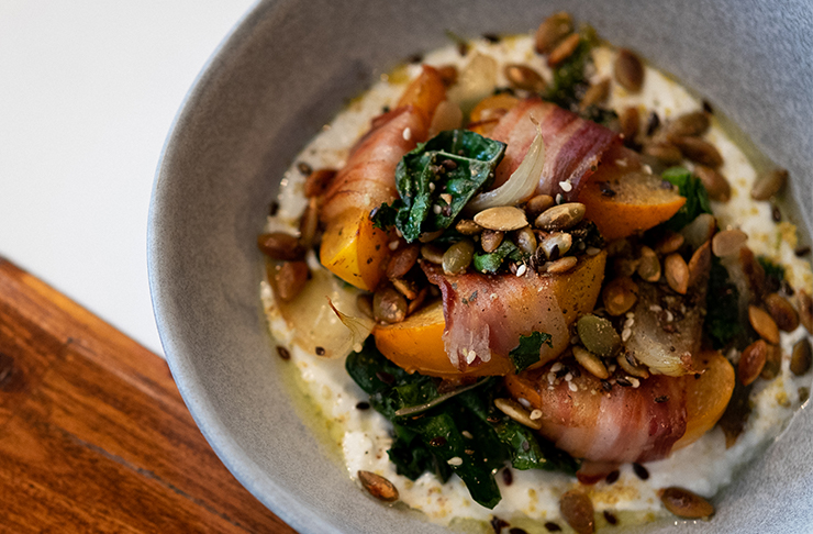 a close up of a prosciutto and pear dish