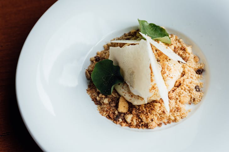 a dessert with crumble and chocolate shards