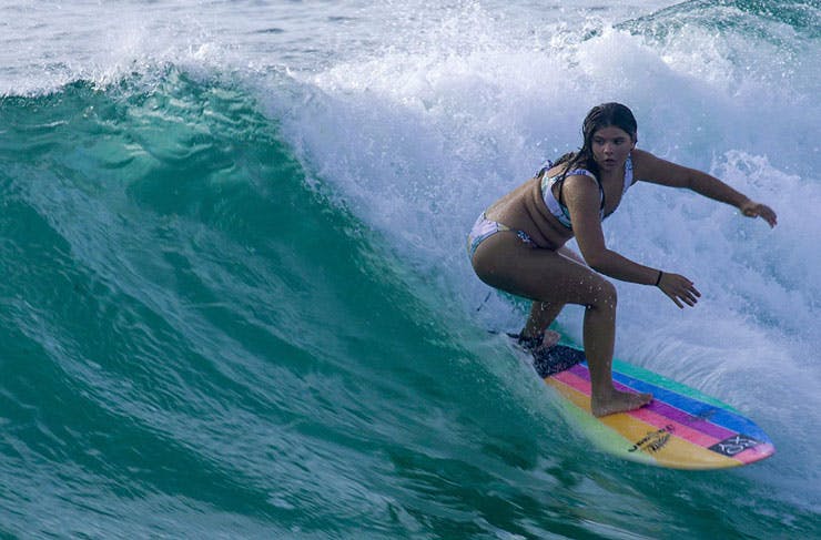 Surfer and surfboard shaper Jalaan Slabb catching a wave. 