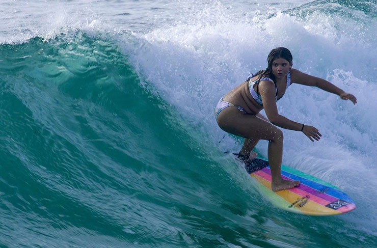 Surfer and surfboard shaper Jalaan Slabb catching a wave. 