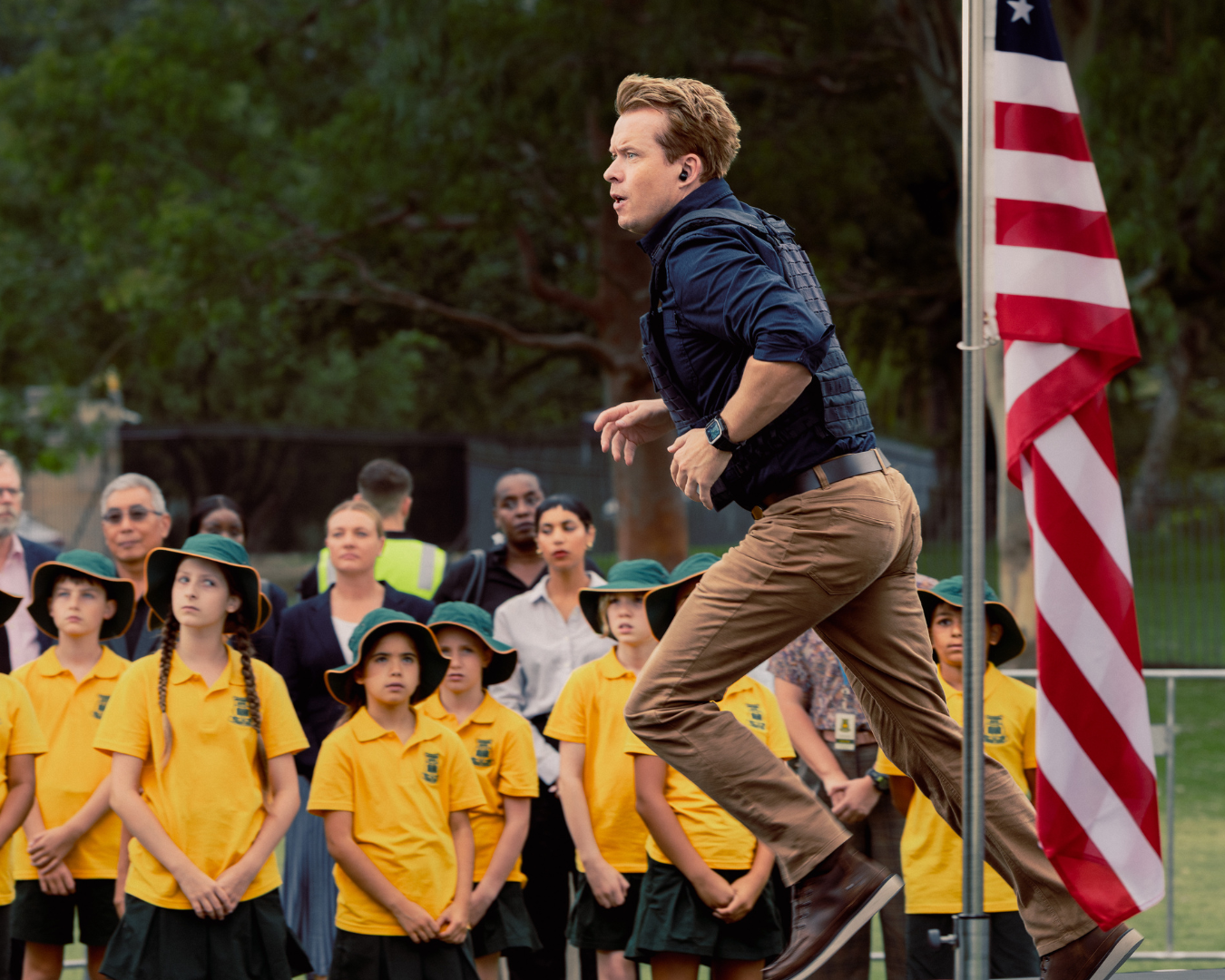 Person running in front of children