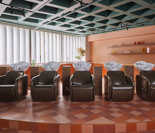 Luxe chocolate leather chairs at the basins at Studio HER hair salon in Darlinghurst. 