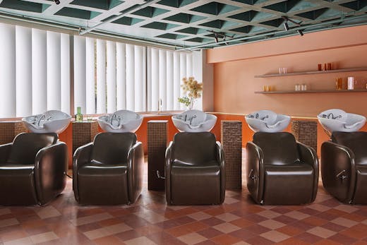 Luxe chocolate leather chairs at the basins at Studio HER hair salon in Darlinghurst.