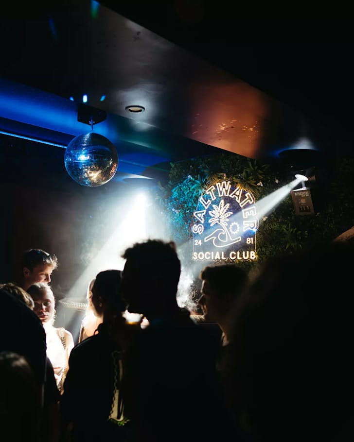 A dark room lit with a disco ball at Saltwater Social Club in Byron Bay