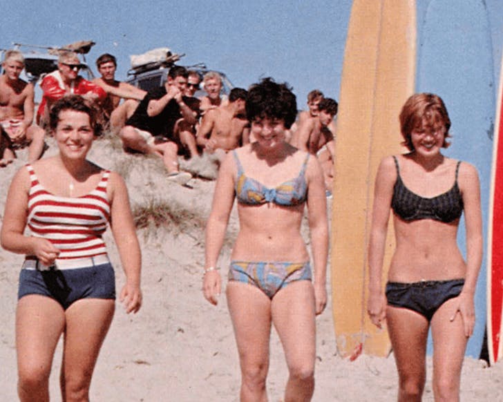 A retro shot of people at the beach, perhaps in the '50s.