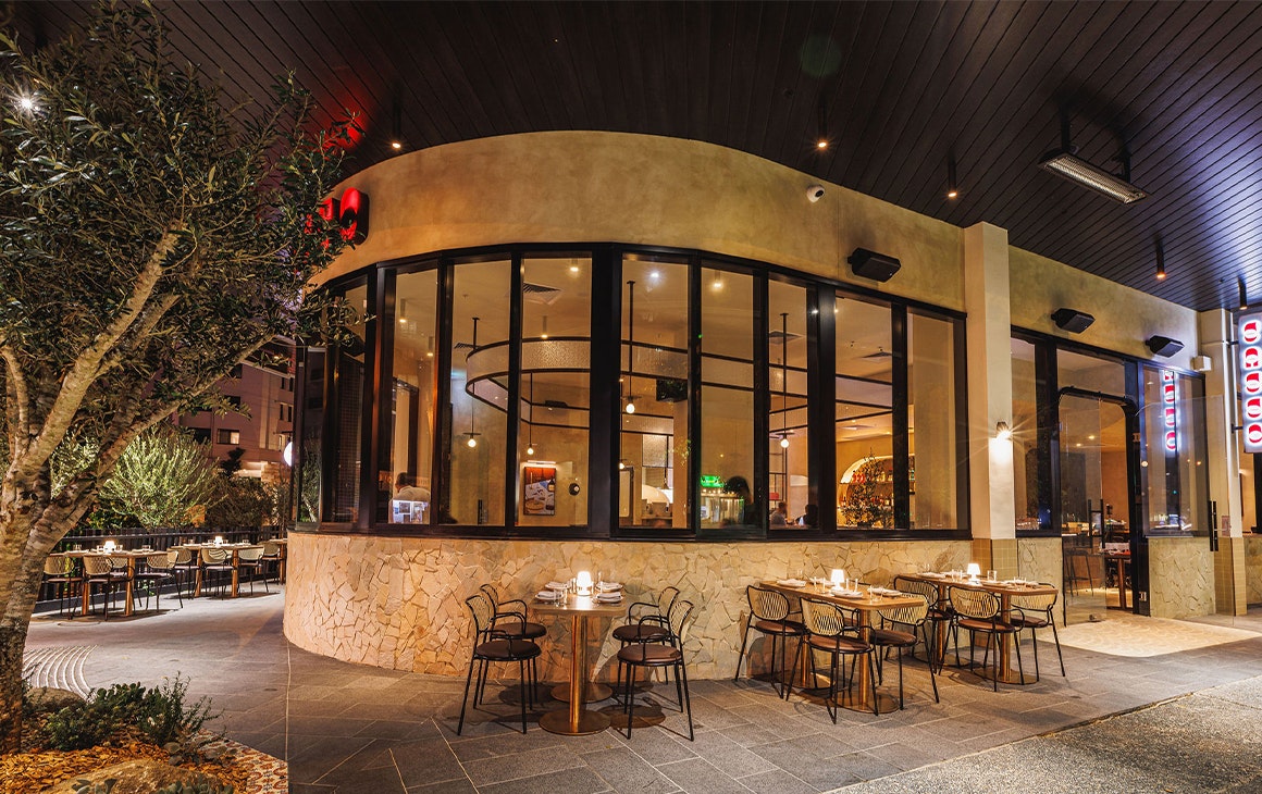 front facade of sasso, with windows looking in and tables outside