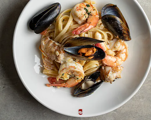 bowl of spaghetti with muscles and seafood