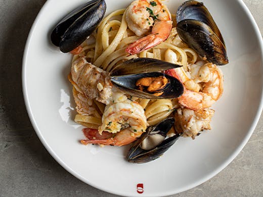 bowl of spaghetti with muscles and seafood