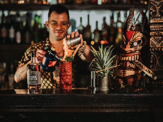 A barman making a tiki cocktail at Scallywags Bondi Beach