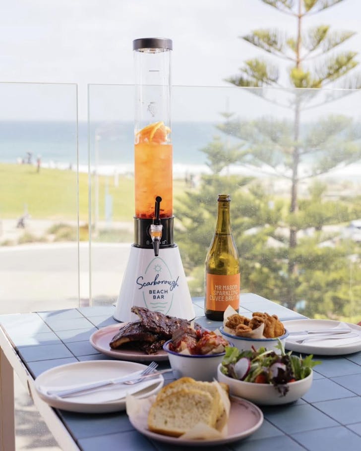 âBottomless brunch at Scarborough Beach Bar with Aperol spritz tower, sparkling wine, barbecue ribs, salad, and ocean views over Scarborough Beach in Perth.â