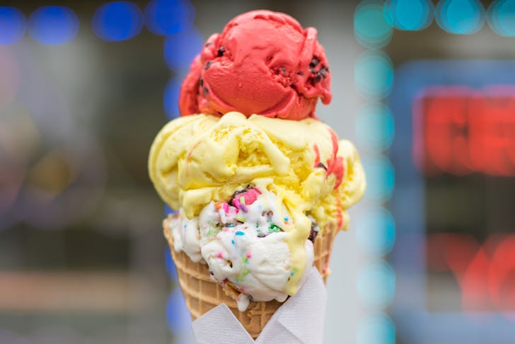 three scoops of ice cream stacked on a waffle cone